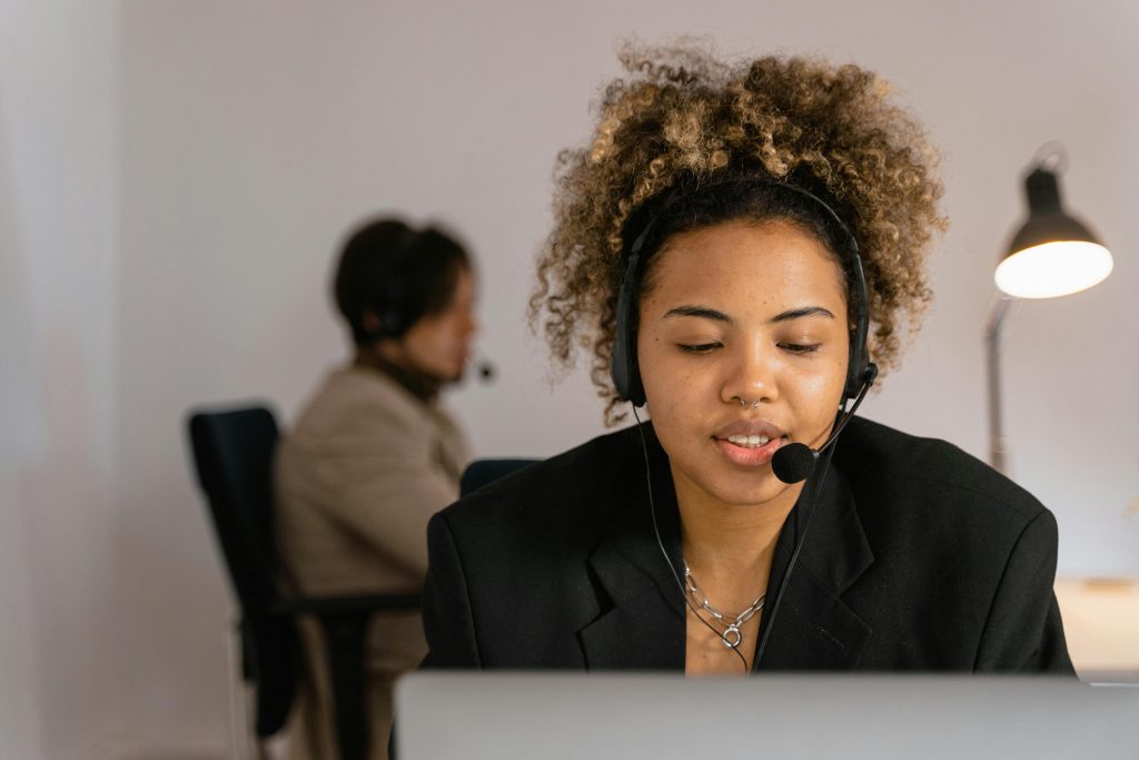 pexels photo 7709242 7709242 Female customer support agent in an office wearing a headset for effective communication.